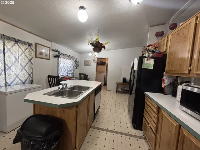 a kitchen with sink cabinets and stove
