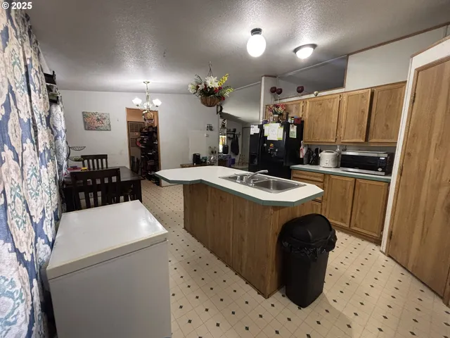 a kitchen with a sink a stove and refrigerator