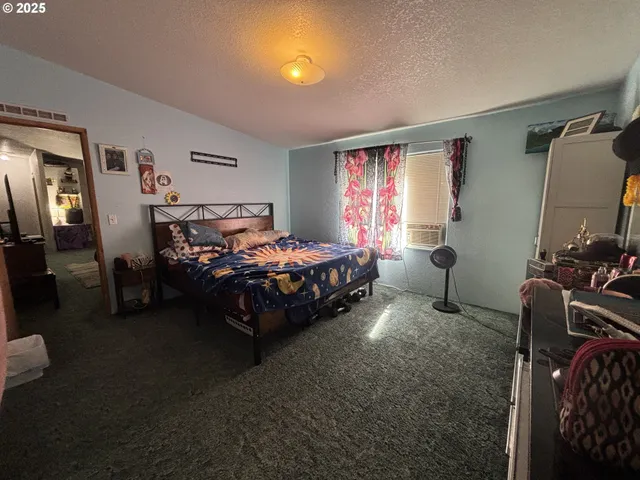 a bed sitting in a bedroom next to a window