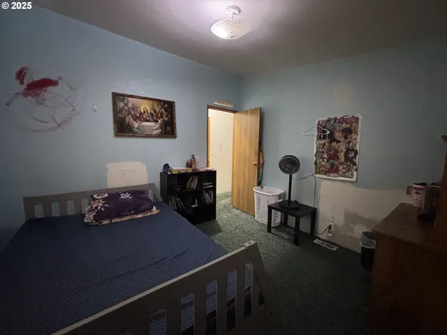 a bedroom with a bed and a table in it