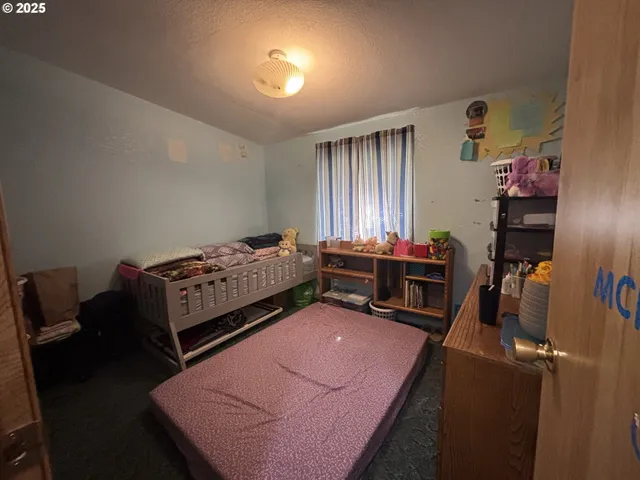 a bedroom with bed and a window