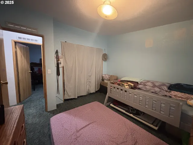 a bedroom with a bed and a cabinet