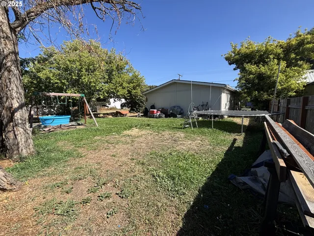 a view of a house with a yard and tree s