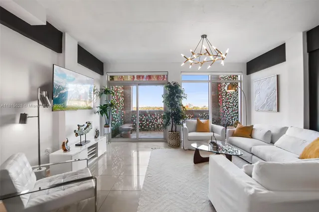 a living room with furniture and a chandelier