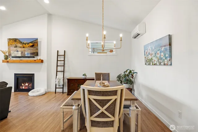 a view of a dining room with furniture and fireplace