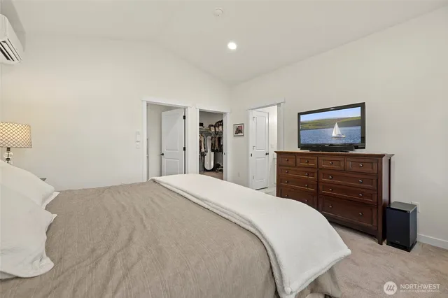 a bedroom with a bed and a flat screen tv