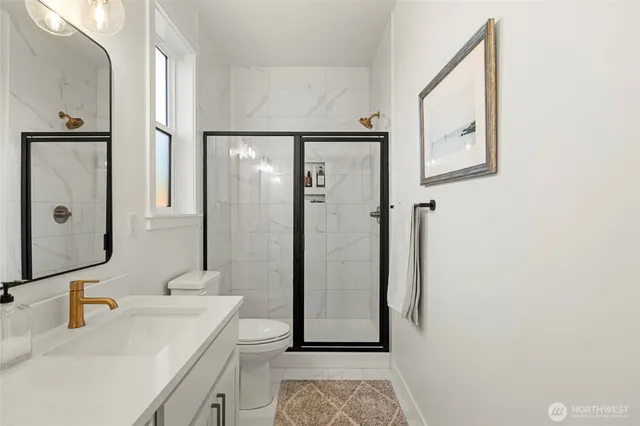 a bathroom with a sink a mirror and a shower