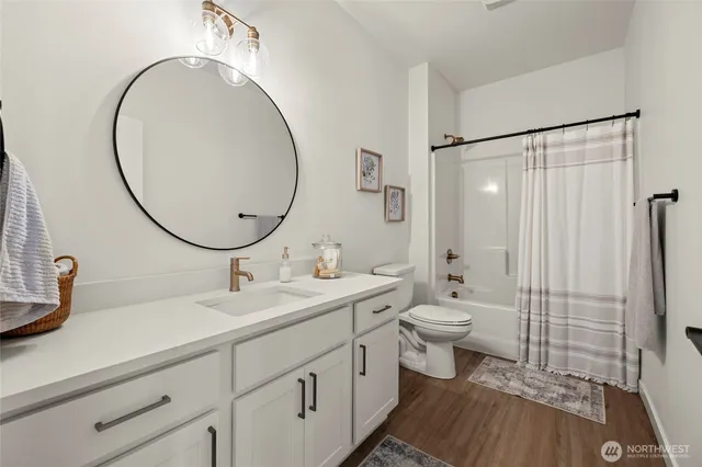 a bathroom with a double vanity sink mirror and toilet