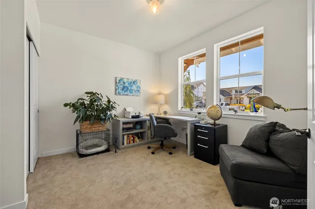 a livingroom with workspace and a window