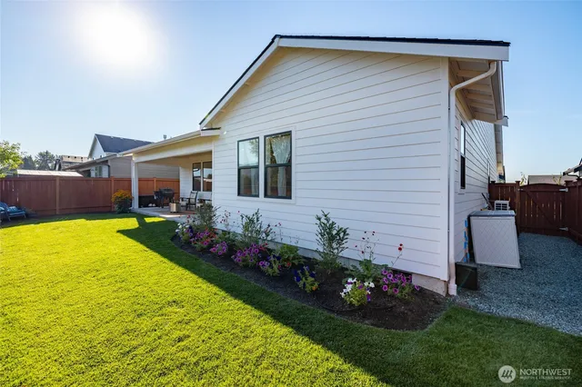 a view of an house with backyard space and garden