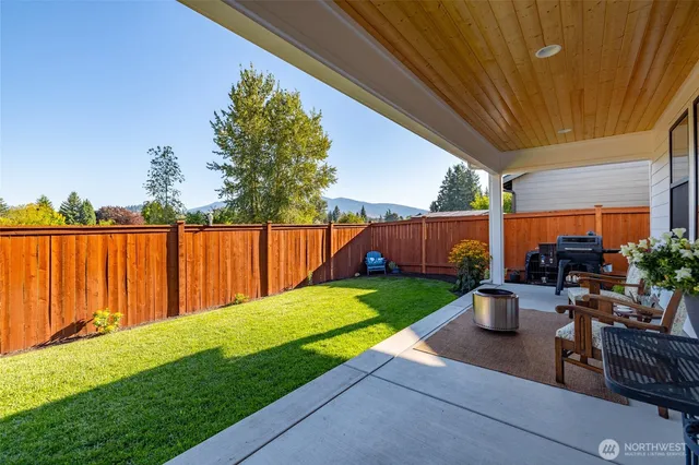 a view of a backyard with sitting area and a garden