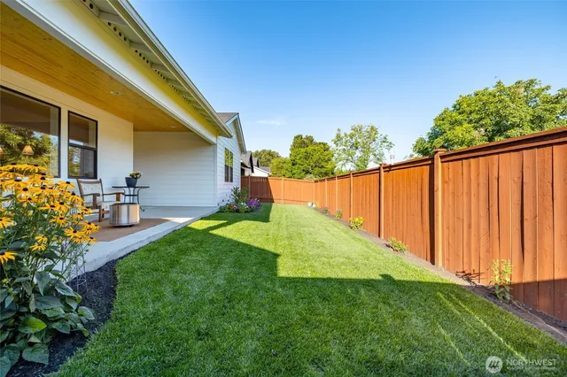 a view of a backyard with plants and a garden