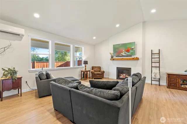 a living room with fireplace furniture and a flat screen tv