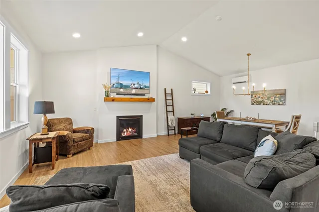 a living room with furniture a fireplace and a flat screen tv