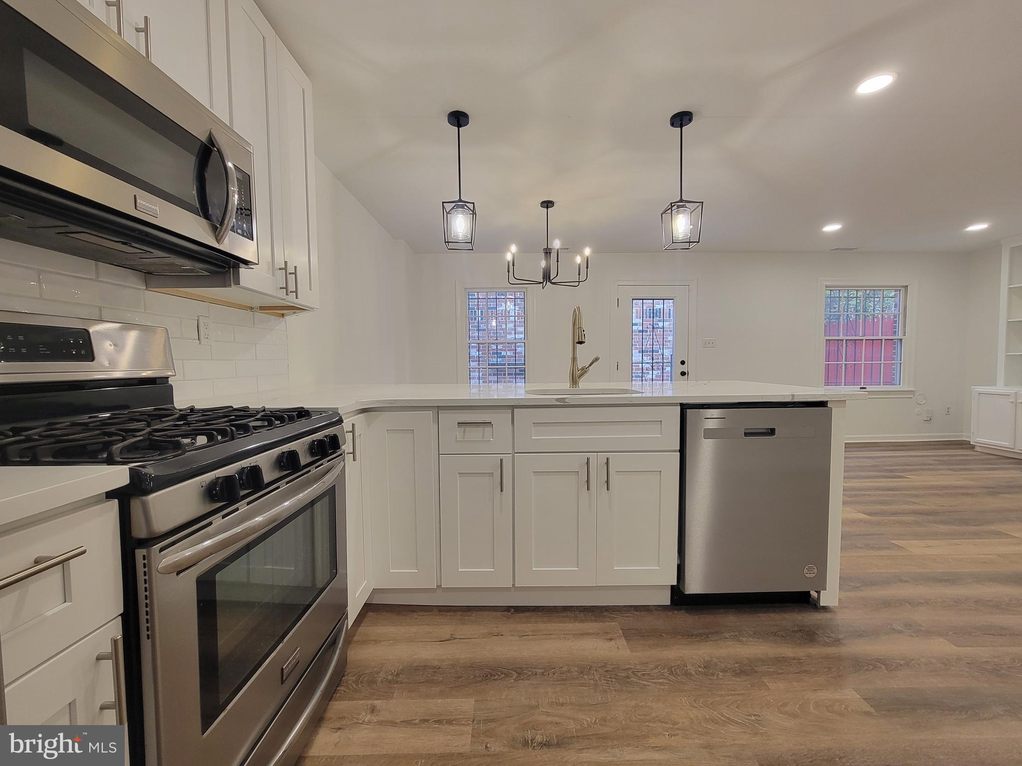 1727 Fitzwater Street, Unit B Philadelphia, PA 19146 - Photo 13 of 31 a kitchen with a stove and a microwave