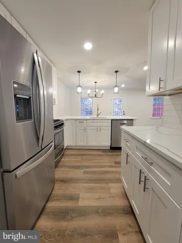 a large kitchen with cabinets and stainless steel appliances