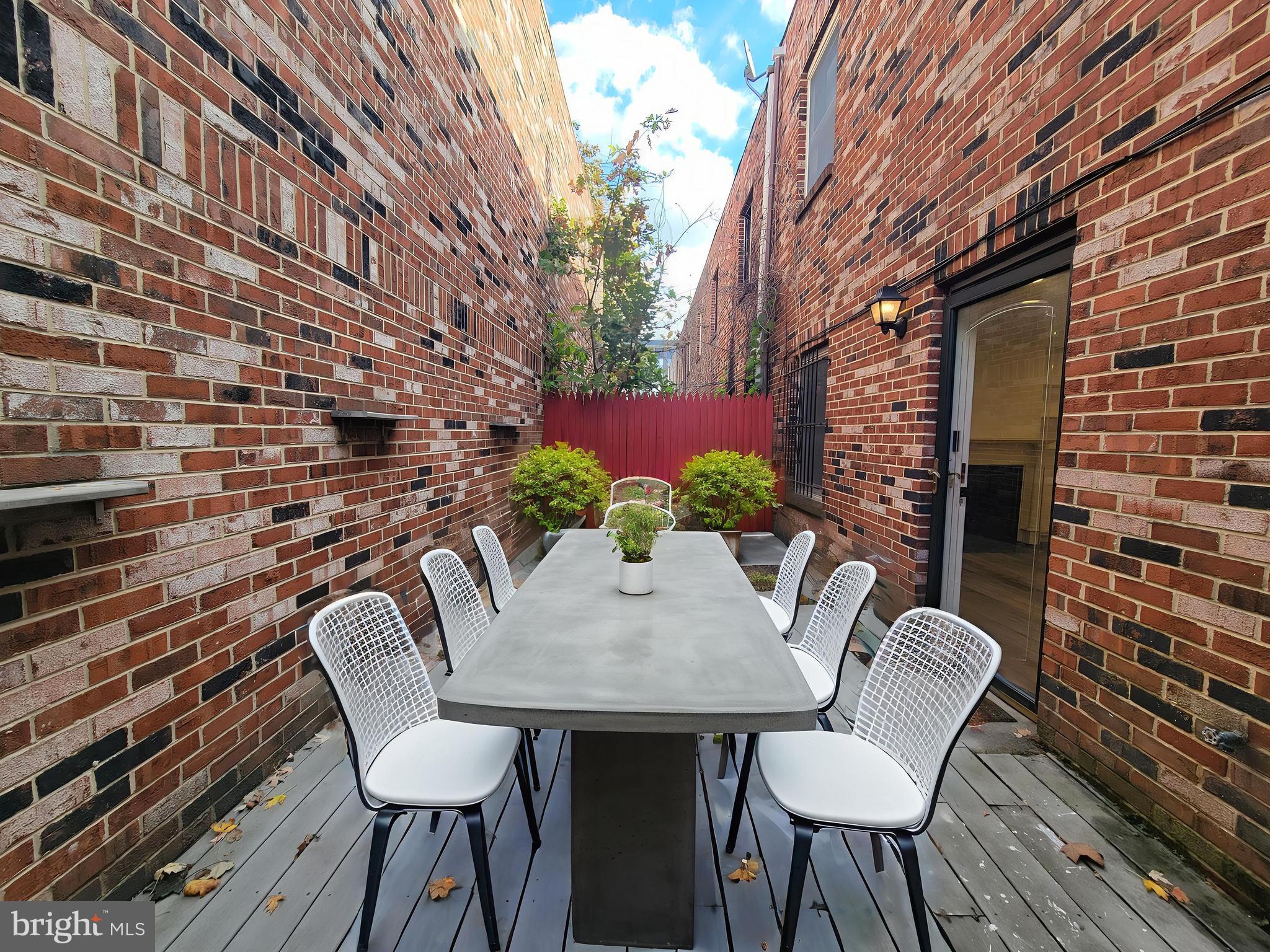 1727 Fitzwater Street, Unit B Philadelphia, PA 19146 - Photo 5 of 31 a backyard of a house with table and chairs