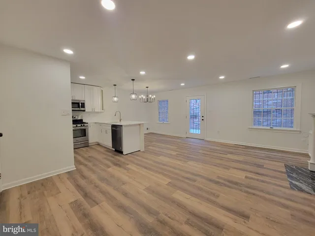 a view of a kitchen with a microwave and a stove top oven