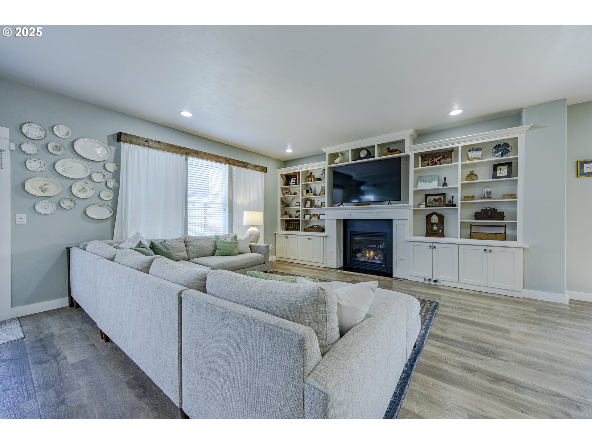 2409 Crowther Drive Eugene, OR 97404 - Photo 13 of 48 a living room with furniture a flat screen tv and a fireplace