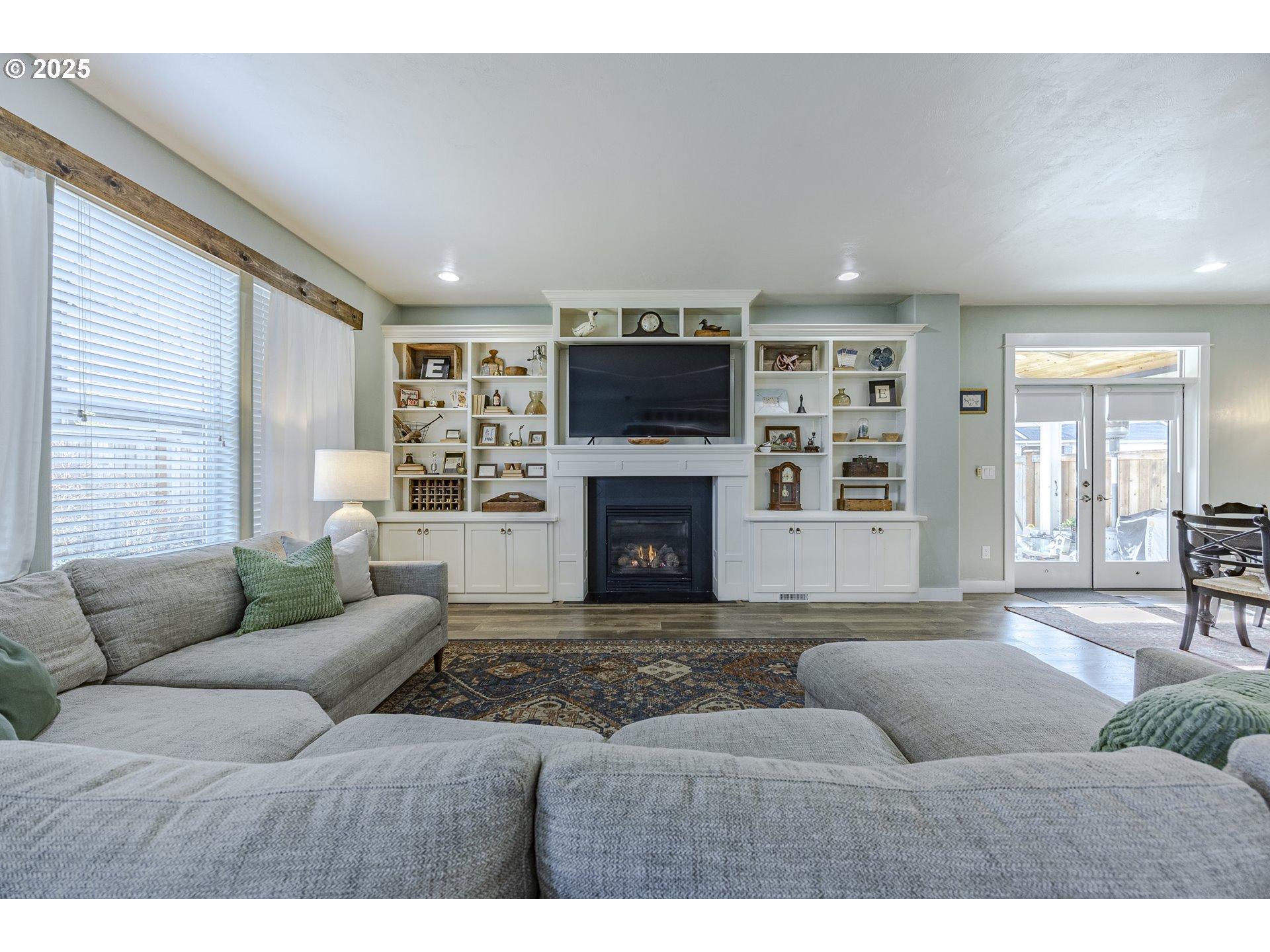 2409 Crowther Drive Eugene, OR 97404 - Photo 14 of 48 a living room with furniture a flat screen tv and a fireplace