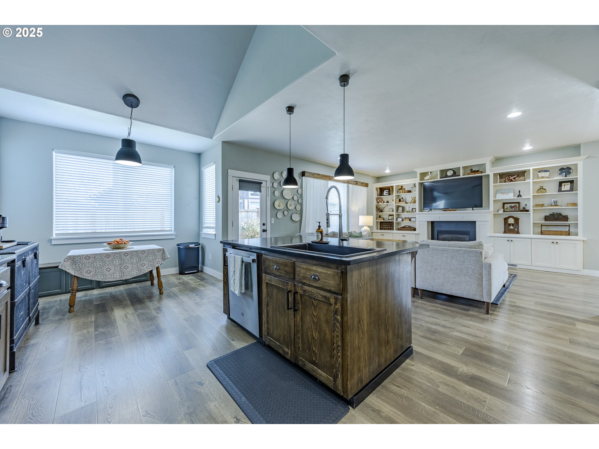 2409 Crowther Drive Eugene, OR 97404 - Photo 19 of 48 a kitchen with stainless steel appliances kitchen island granite countertop a stove a sink a refrigerator and wooden floors
