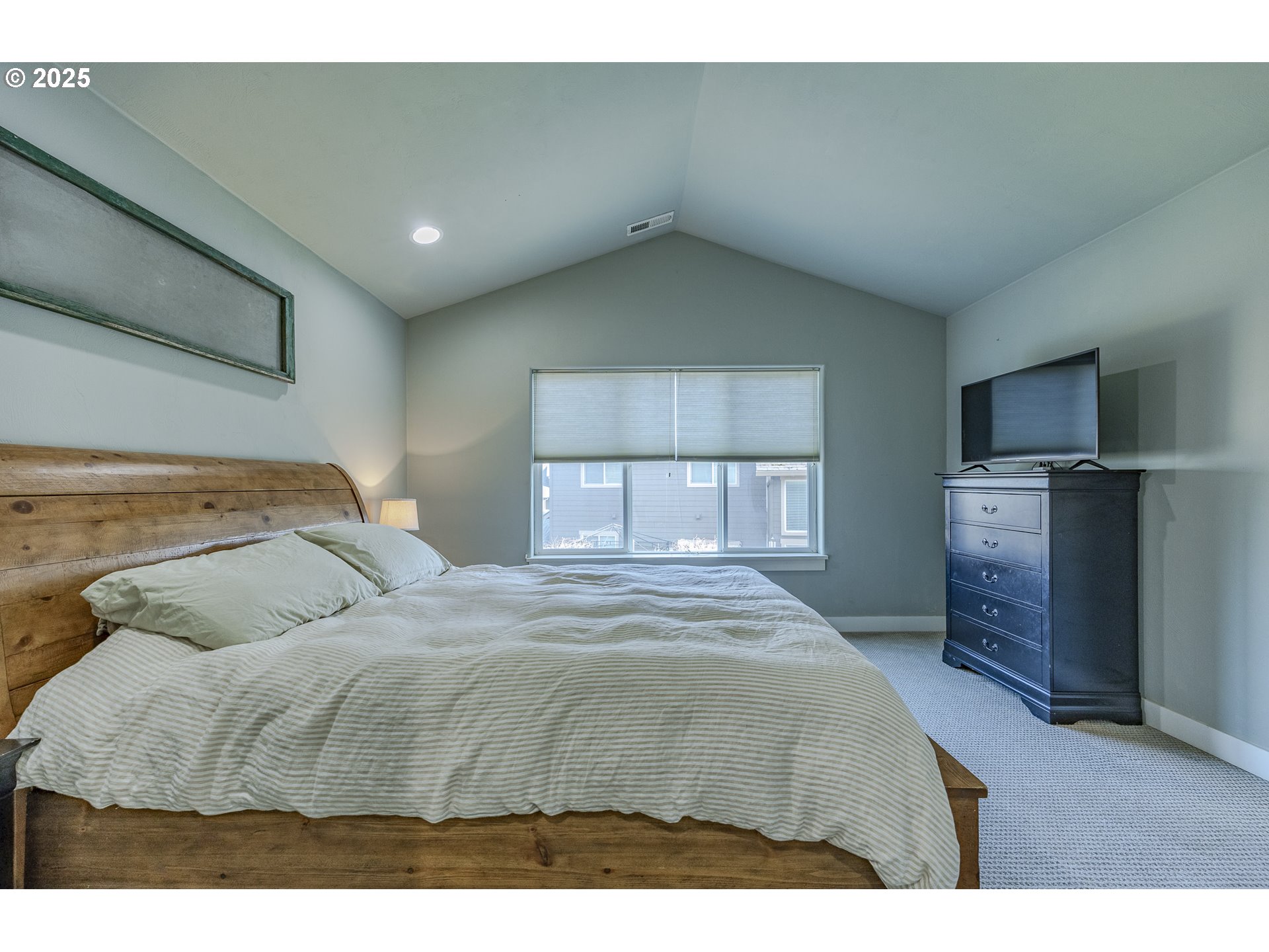 2409 Crowther Drive Eugene, OR 97404 - Photo 24 of 48 a bedroom with a large bed and a flat tv screen on dresser