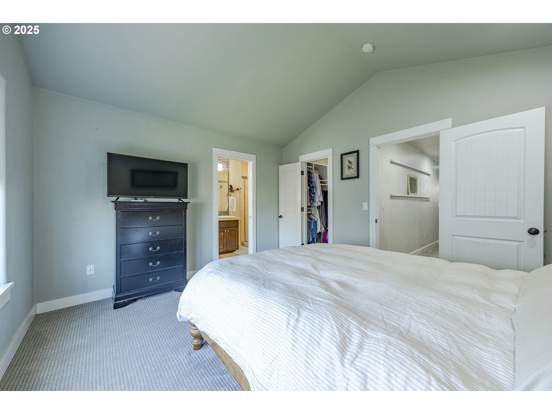 2409 Crowther Drive Eugene, OR 97404 - Photo 27 of 48 a spacious bedroom with a bed and a flat screen tv