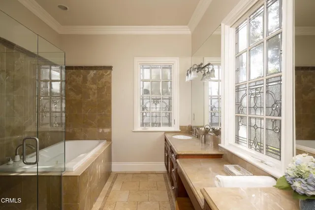 a spacious bathroom with a granite countertop tub shower and sink