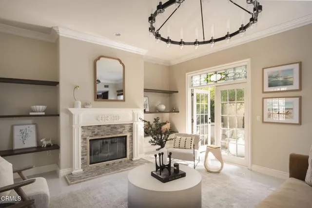 a living room with furniture a fireplace and a table