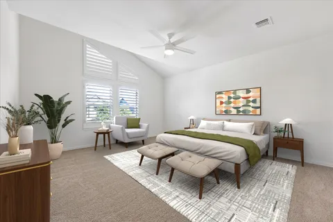 a bedroom with furniture and a large window