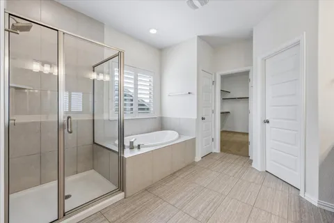 a bathroom with a tub and shower