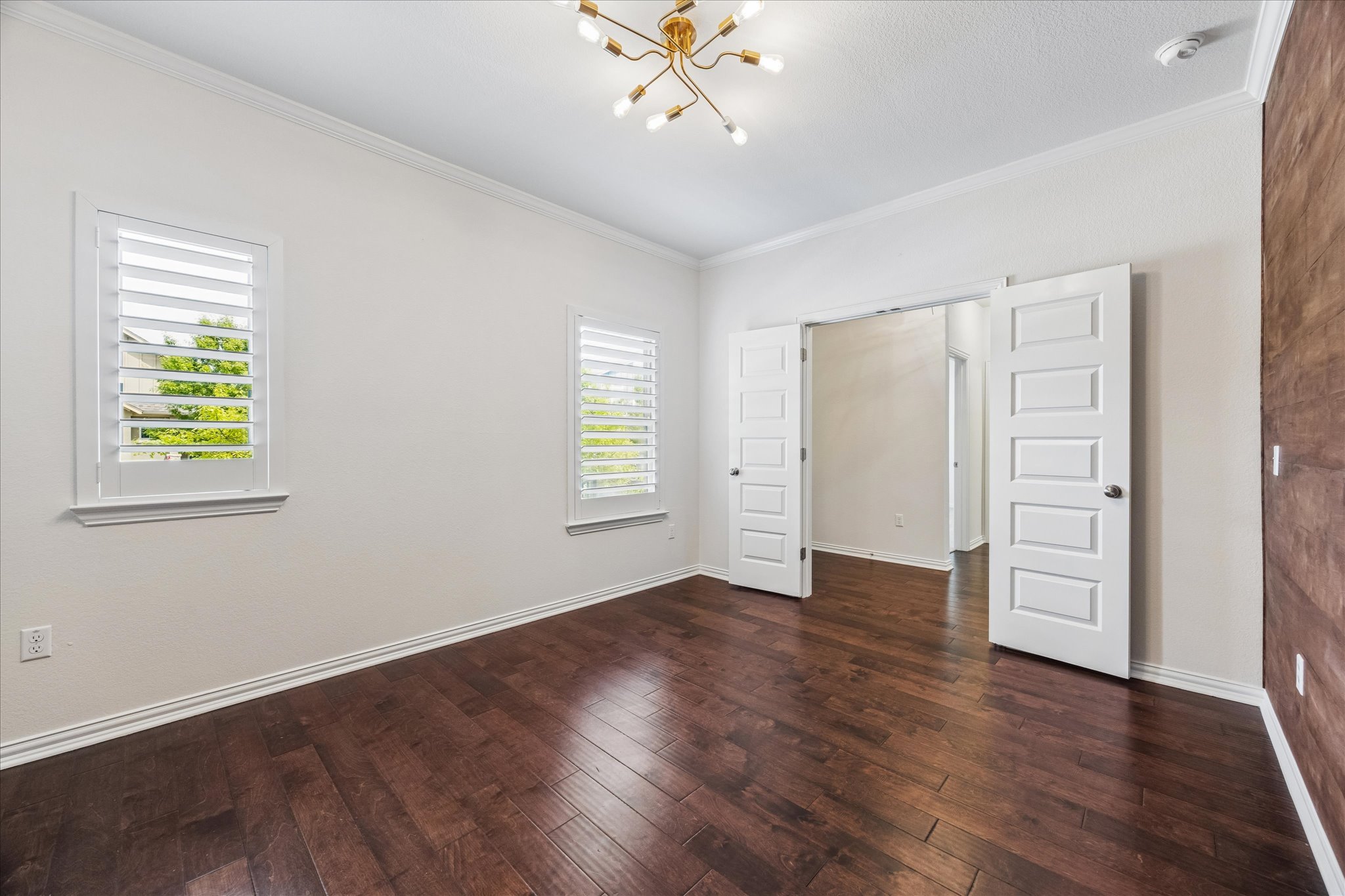 8816 Cattle Baron Path Austin, TX 78747 - Photo 5 of 32 an empty room with wooden floor closet and windows