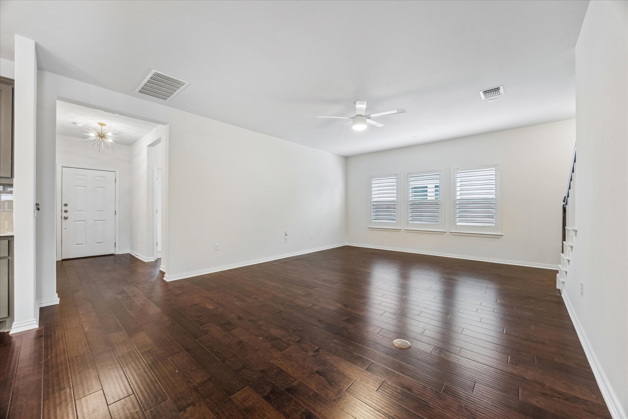 8816 Cattle Baron Path Austin, TX 78747 - Photo 7 of 32 an empty room with wooden floor and windows