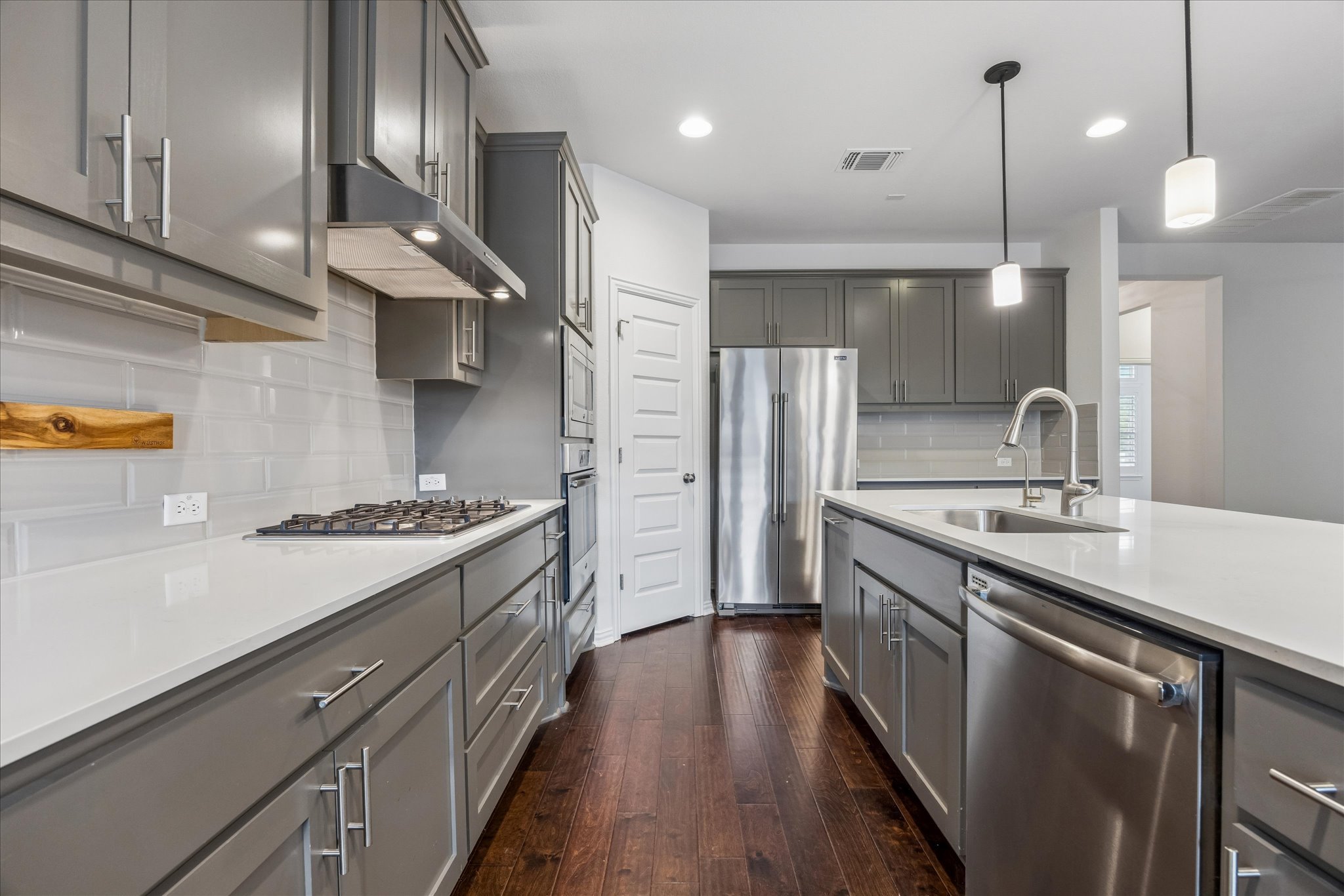 8816 Cattle Baron Path Austin, TX 78747 - Photo 9 of 32 a kitchen with stainless steel appliances granite countertop a sink a stove and a refrigerator