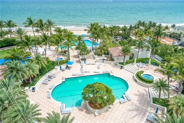 a swimming pool with outdoor seating and yard