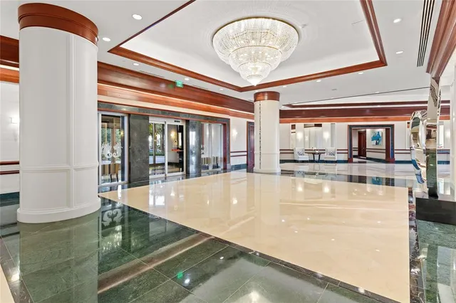 a living room with couches and kitchen view with wooden floor