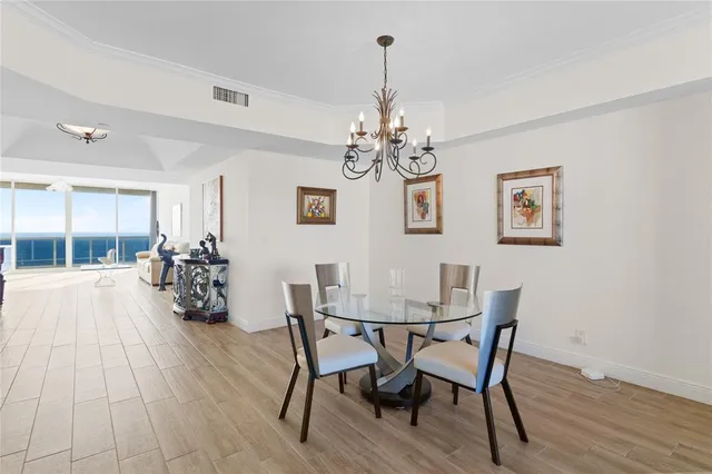 a view of a dining room with furniture wooden floor and chandelier