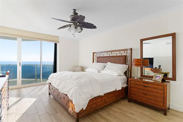 a large bedroom with a bed and large mirror