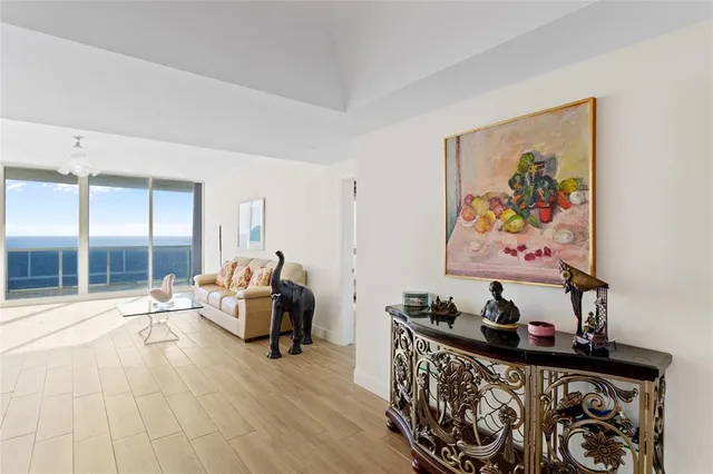 a bedroom with furniture and a large window