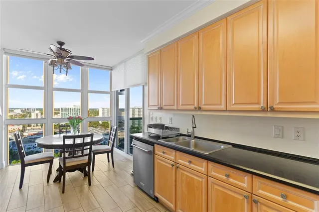 a kitchen with granite countertop a sink a counter top space and stainless steel appliances
