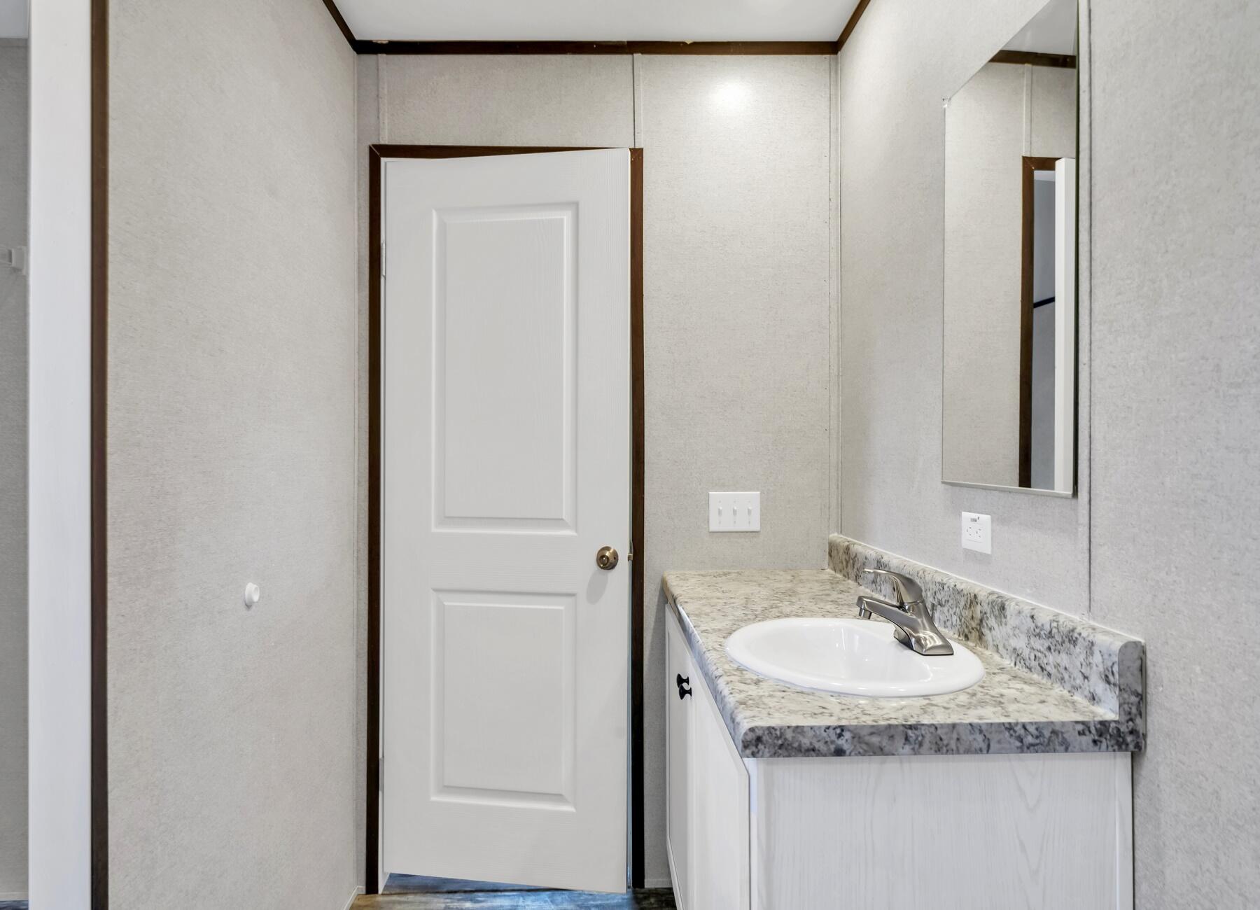 173 Gregory Dean Lane DeFuniak Springs, FL 32433 - Photo 20 of 24 a bathroom with a granite countertop sink and a mirror