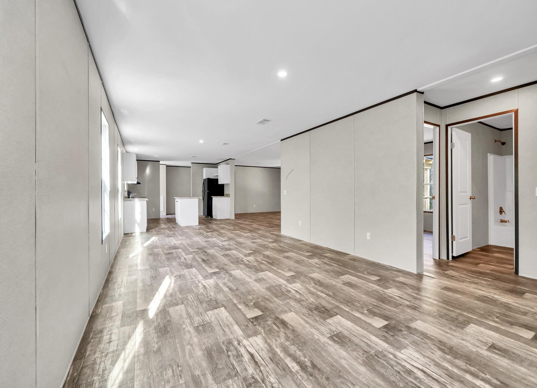 173 Gregory Dean Lane DeFuniak Springs, FL 32433 - Photo 24 of 24 a view of a big room with wooden floor and windows