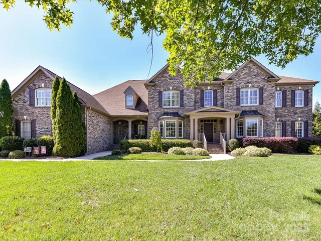 a front view of a building with a yard