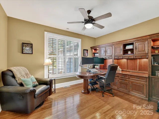 a view of staircase with lots of frames on wall and a rug