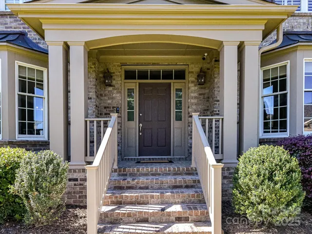 a front view of a house with a glass windows