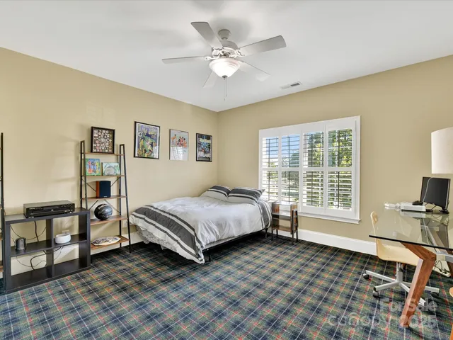 a view of room with walk in closet and wooden floor