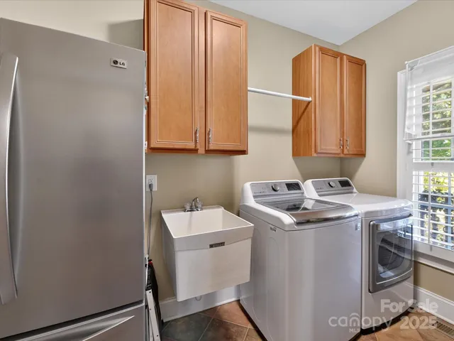 a living room with furniture and floor to ceiling windows