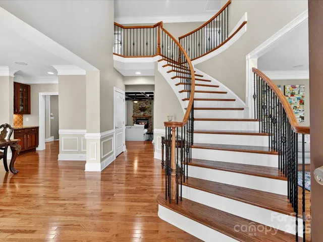a view of entryway and hall with wooden floor