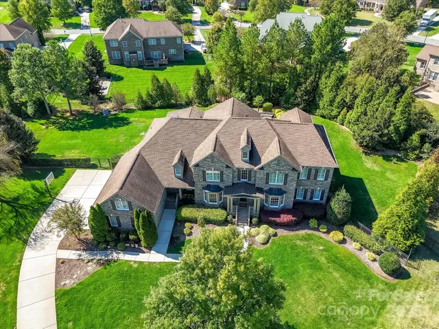 an aerial view of a house with garden space and street view