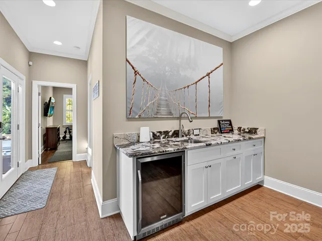 a kitchen with a sink cabinets and wooden floor